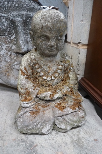 A reconstituted stone Buddha mask garden ornament, height 50cm, together with a seated Buddha garden ornament